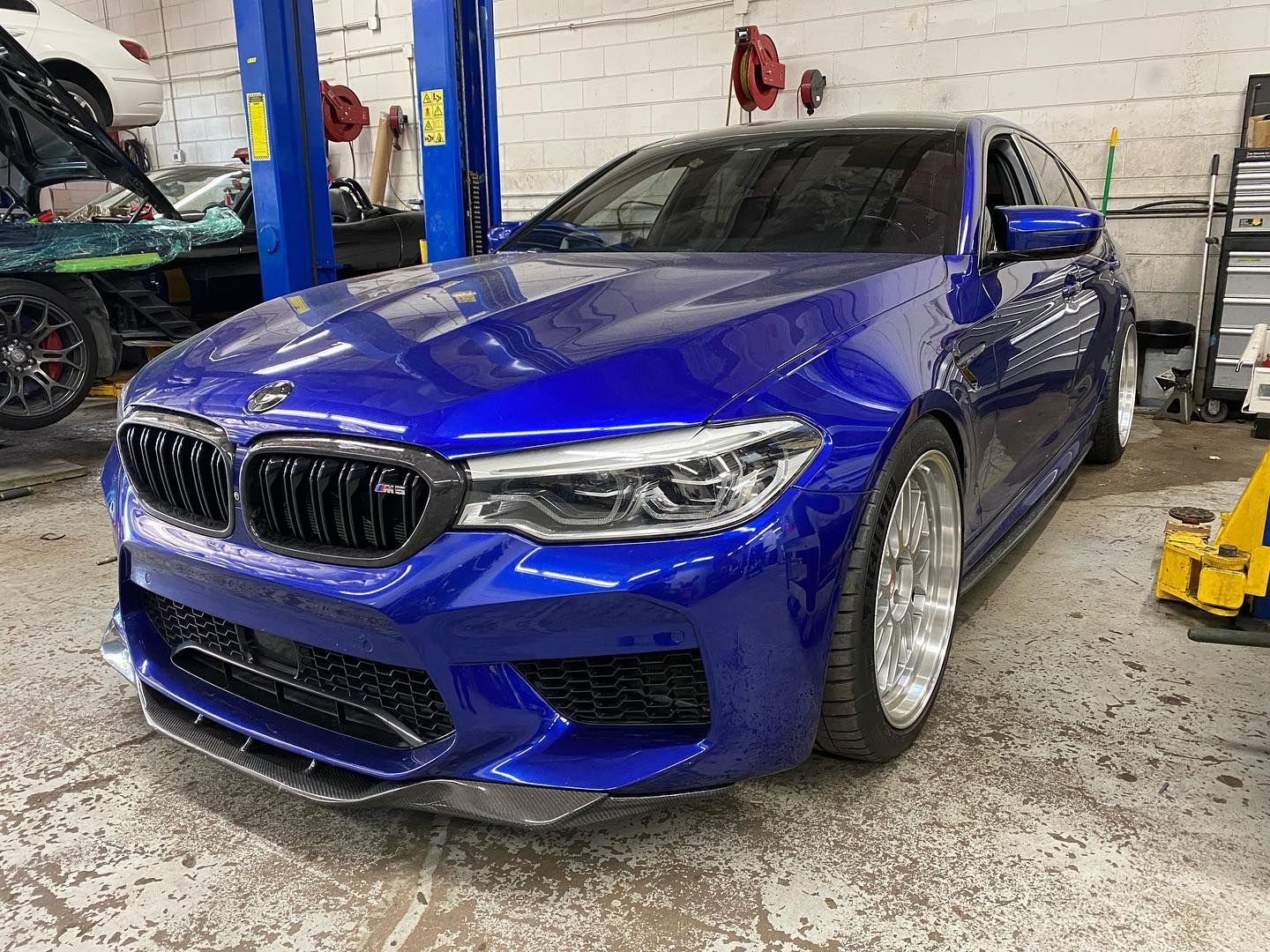 Blue F90 M5 in the service bay