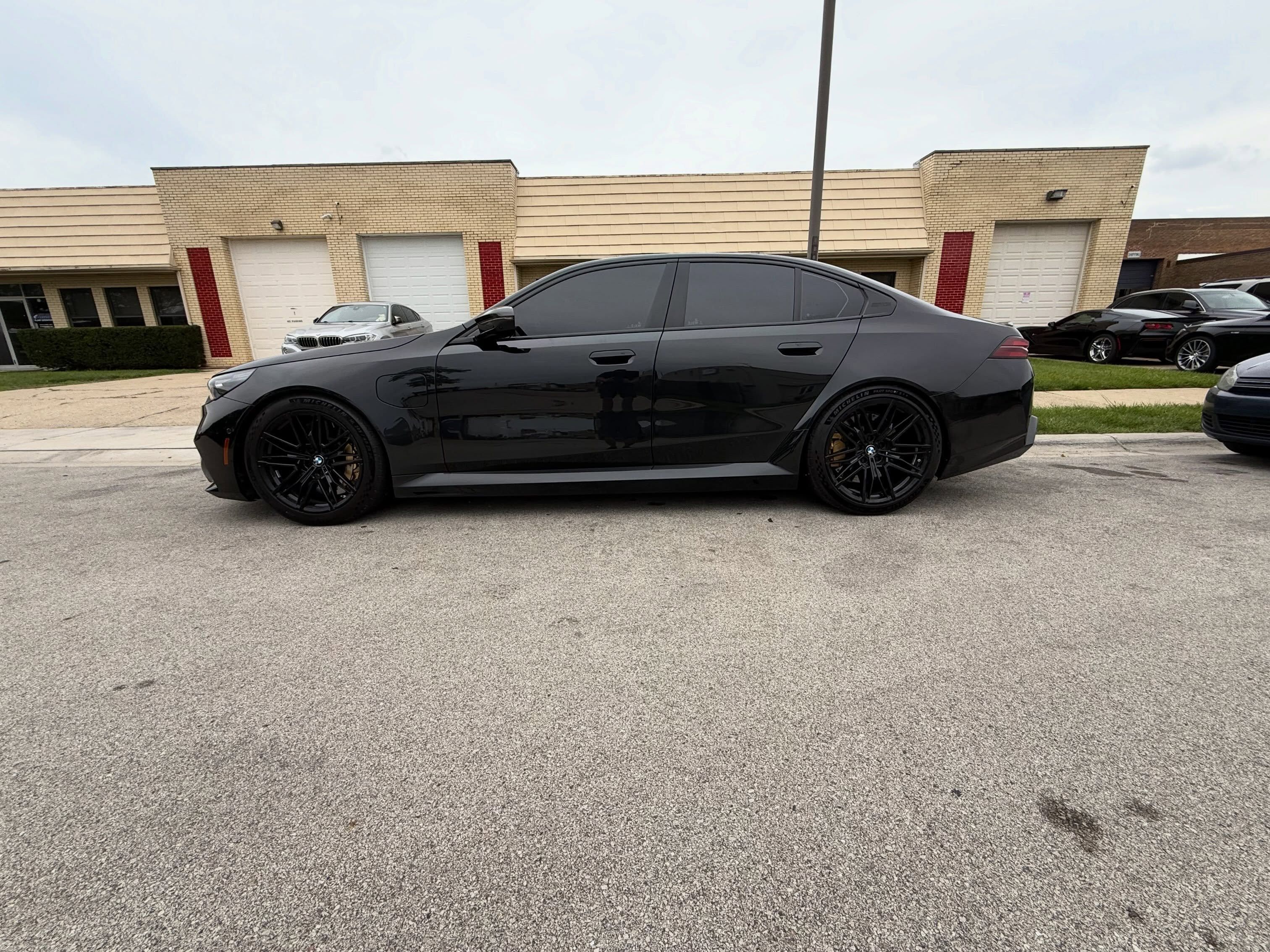 Rear of a black G90 M5 after suspension and intake work