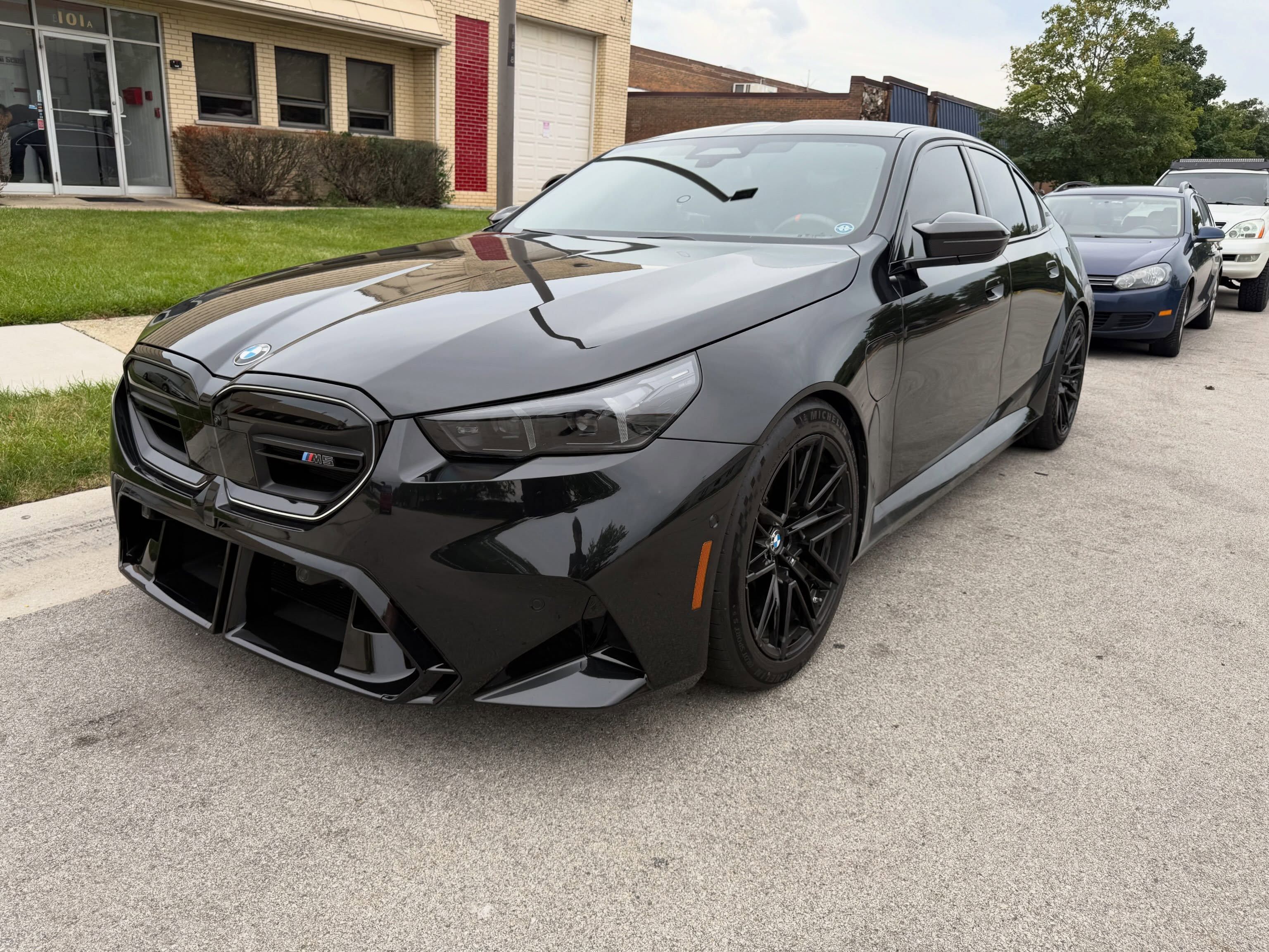 Black G90 M5 outside Horse Stable Automotive in Elk Grove Village after lowering springs and Eventuri intakes